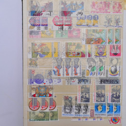 Vrac philatélique de timbres du monde neufs et oblitérés en un carton.