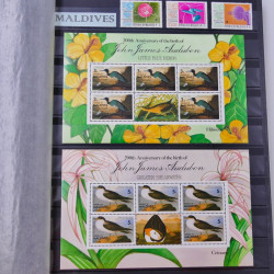 Lot de timbres de Maldives, Guernesey, Honduras neufs et oblitérés en un album.