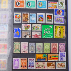 Lot de timbres d'Ethiopie et Dominique neufs et oblitérés en un album.