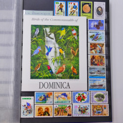 Lot de timbres d'Ethiopie et Dominique neufs et oblitérés en un album.