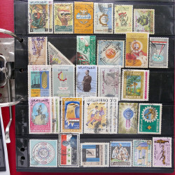 Lot massif de timbres d'Asie - Moyen Orient neufs et oblitérés en un album.