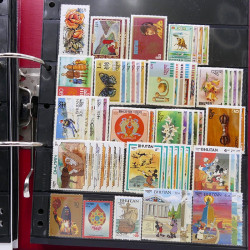 Lot massif de timbres d'Asie - Moyen Orient neufs et oblitérés en un album.