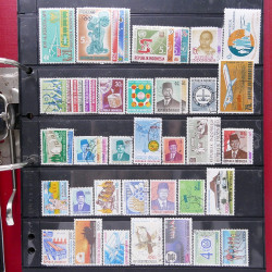 Lot massif de timbres d'Asie - Moyen Orient neufs et oblitérés en un album.