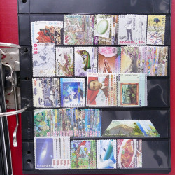 Lot massif de timbres d'Asie - Moyen Orient neufs et oblitérés en un album.