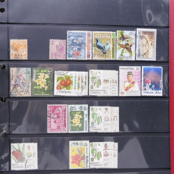 Lot massif de timbres d'Asie - Moyen Orient neufs et oblitérés en un album.