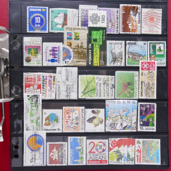 Lot massif de timbres d'Asie - Moyen Orient neufs et oblitérés en un album.