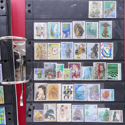 Lot massif de timbres d'Asie - Moyen Orient neufs et oblitérés en un album.