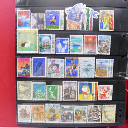 Lot massif de timbres d'Asie - Moyen Orient neufs et oblitérés en un album.