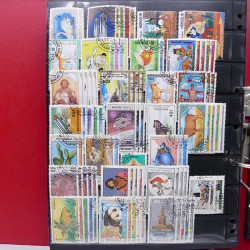 Lot massif de timbres d'Asie - Moyen Orient neufs et oblitérés en un album.