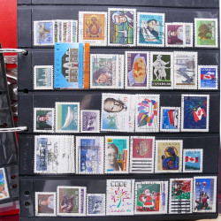 Lot massif de timbres d'Amérique et Afrique neufs et oblitérés en album.
