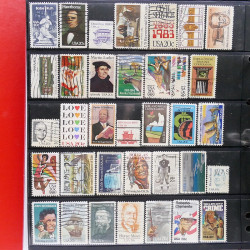 Lot massif de timbres d'Amérique et Afrique neufs et oblitérés en album.