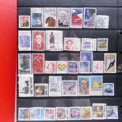 Lot massif de timbres d'Amérique et Afrique neufs et oblitérés en album.