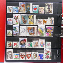 Lot massif de timbres d'Amérique et Afrique neufs et oblitérés en album.