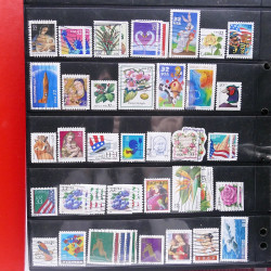 Lot massif de timbres d'Amérique et Afrique neufs et oblitérés en album.