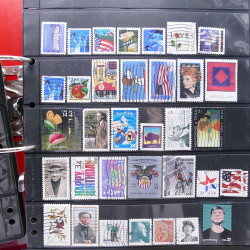 Lot massif de timbres d'Amérique et Afrique neufs et oblitérés en album.