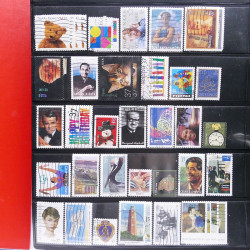 Lot massif de timbres d'Amérique et Afrique neufs et oblitérés en album.