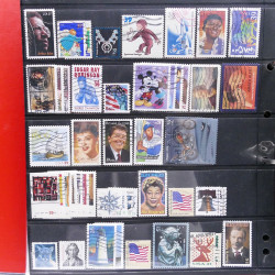 Lot massif de timbres d'Amérique et Afrique neufs et oblitérés en album.