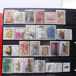 Lot massif de timbres d'Amérique et Afrique neufs et oblitérés en album.