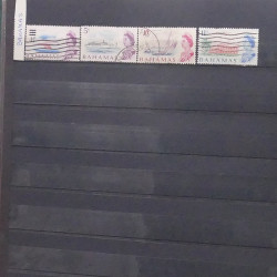 Lot de timbres d'Amérique neufs et oblitérés en un album.