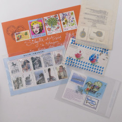 Vrac philatélique de timbres du monde neufs et oblitérés en un carton.