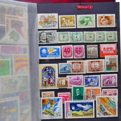 Vrac philatélique de timbres du monde neufs et oblitérés en un carton.