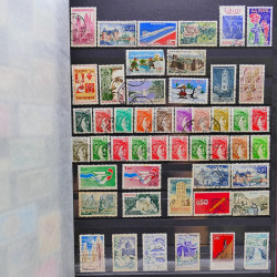 Vrac philatélique de timbres du monde neufs et oblitérés en un carton.