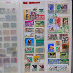 Vrac philatélique de timbres du monde neufs et oblitérés en un carton.